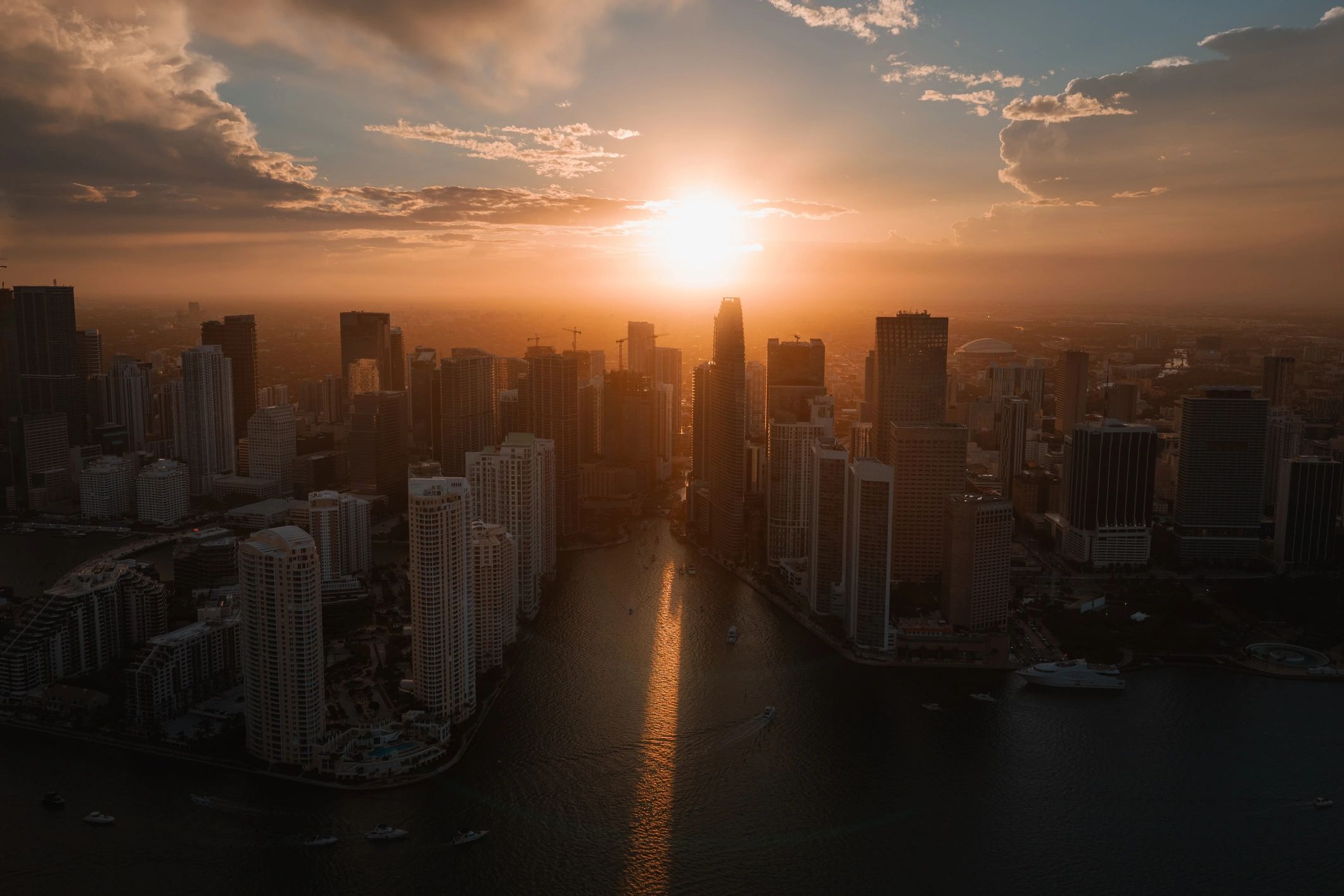 Aerial view of sunset over the Miami River between the Brickell and Downtown Miami skylines